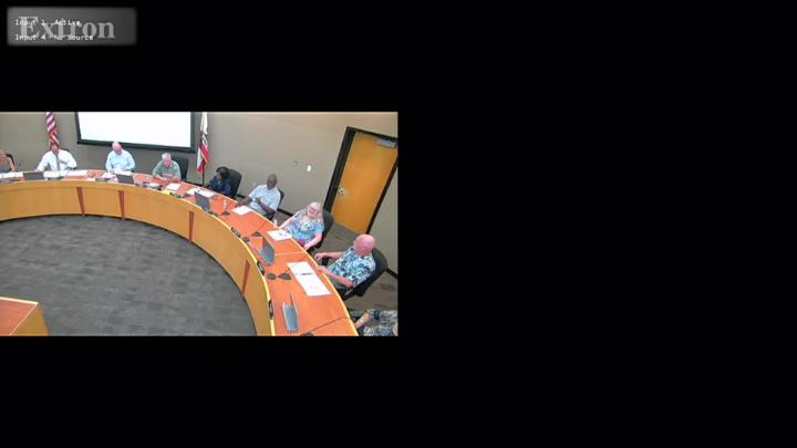 A graphic announcing a Planning Commission Meeting for the City of Tracy. The background shows a soft-focus image of a busy street, lined with arts and crafts vendors. At the top is the City of Tracy logo with stylized green and brown lines. To the right is a QR code labeled “Scan for Meeting Agenda.” In the center, large text reads “City of Tracy Planning Commission Meeting.” A green banner at the bottom displays the date and time: “April 8, 2026, at 7:00 p.m.”